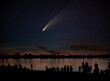 Comet Neowise comet C/2020 F3 (NEOWISE) and crowd of people  silhouetted by the Ottawa river watching and photographing the comet
