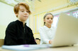 © DmitryStock - A girl in a white shirt and a boy in a black sweater study online using a computer