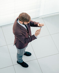 Wall Mural - top view. business man looking at the screen of his smartphone.