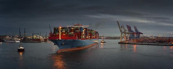 Large container ship at a terminal in the early evening 