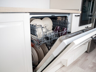 dishwasher close-up with washed dishes, easy to use and save water, eco-friendly, built-in kitchen dish washing machine