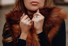 Young Woman With Cropped Head In A Fur Coat. Outdoor Portrait In Daylight. Warm Winter Clothes Concept