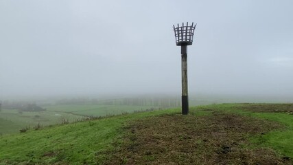 Wall Mural - Beacon at Winchelsea looking over Brede Valley on misty day, sheep in fields - Winchelsea, East Sussex, UK