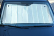 Sun shade under windshield inside car, closeup. Heat protection