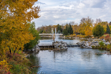 Poster - Prince's Island Park Jaipur Bridge at Bow river bank. Autumn foliage scenery in downtown Calgary, Alberta, Canada.