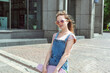 © Елена Гурова - portrait of a beautiful caucasian teenage girl with a skateboard with an earphone.