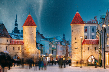 Tallinn, Estonia. Night Starry Sky Above Famous Landmark Viru Gate Gates. Street Lighting In Winter Holiday Evening. Christmas Xmas, New Year Vacation In Old Town. UNESCO Heritage. Altered Sky