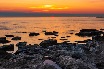 Wall Mural - Colorful sunrise on the rocky sea coast