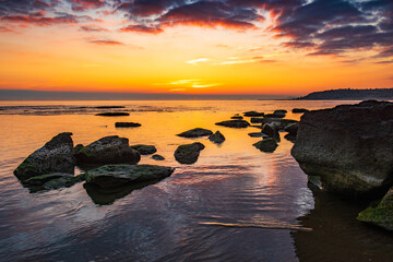 Wall Mural - Colorful sunrise on the rocky sea coast