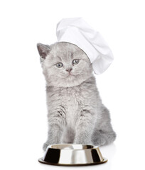 Wall Mural - Kitten wearing chef's hat sits with empty bowl. isolated on white background