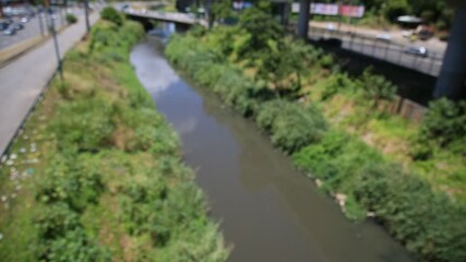 Wall Mural - salvador, bahia, brazil - december 30, 2020: sewage channel on the Camurujipe River is seen in the city of Salvador.