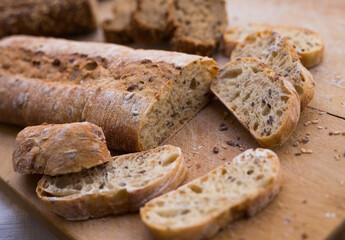 Wall Mural - fresh loaf of bread on wooden board