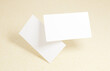 © Garmon - Floating Business Card Mockup. Closeup on two empty business cards floating in the air in front of the cardboard background.