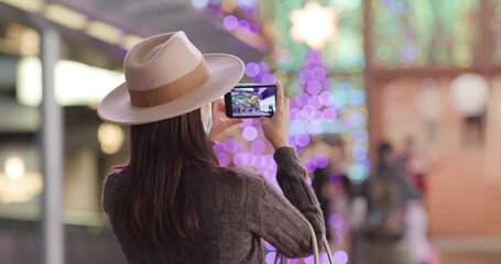 Sticker - Woman use of mobile phone to take photo with christmas decoration at night