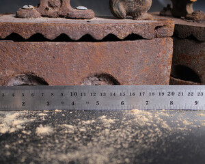 Old rusty antique iron for ironing clothes with the help of charcoal. Household antiques. Iron for clothes made of traditional steel with a wooden handle (Ayam Jago). Detailed photo of an old iron.