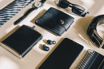 Top view male object, watch, flask, tie, belt, cell phone, wallet, notebook, headphones. Modern male accessories.