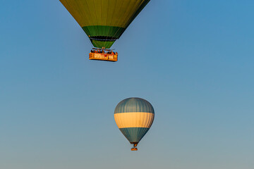 Two hot air balloon flying over Cappadocia in blue sky. balloon under other