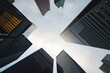 © Ernest - Stunning Metropolitan Lookup View of Skyscrapers in the Financial District during cloudy weather with tall buildings for a busy feel