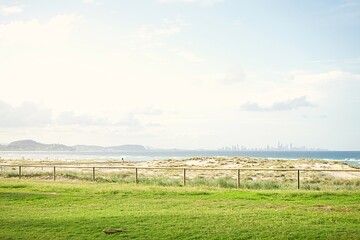 Wall Mural - Surfers Paradise Skyline from Kirra beach. Golden summer evening light on the Gold Coast