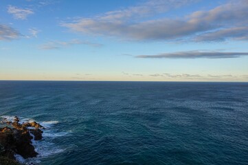 Wall Mural - Looking out to sea at sunset at the most easternly point of mainland Australia