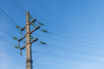 Power transmission tower (or electricity pylon) against blue sky. Tower is used to support an overhead power line. Copy space for your text. Electricity theme.