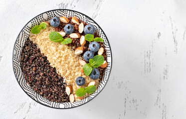 Canvas Print - Bowl of  cooked quinoa with nuts and blueberries