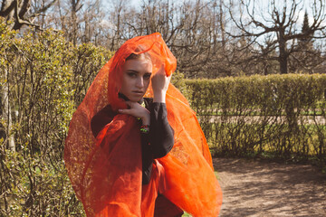 Girl in a red tutu in a city garden