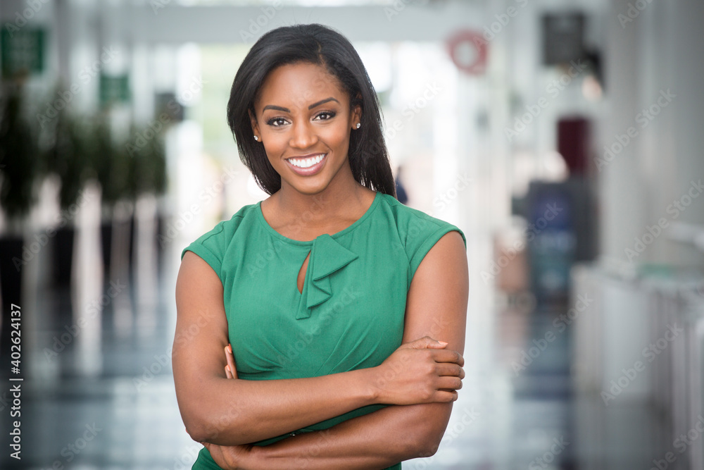 African American woman in green dress in modern corporate building lobby  Stock Photo | Adobe Stock