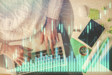 Fototapete - Multi exposure of woman hands working on computer and forex chart hologram drawing. Top View. Financial analysis concept.