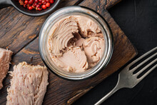 Canned Tuna Fillet In Olive Oil , On Black Background, Flat Lay