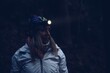 Beauty tourist woman with headlight in the forest at dark