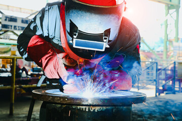 worker with Torch head Mig Mag, Operator welding machine metal steel pipe by MIG welding