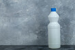White container of bleach on marble background
