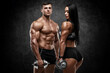 © nikolas_jkd - Sporty couple showing muscles on wall background. Muscular man and woman