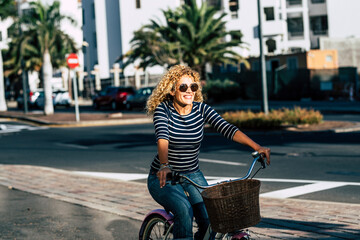 Wall Mural - Cheerful people caucasian woman smile and enjoy bike ride in outdoor leisure activity in the city - active female have fun and have active lifestyle transportation concept free