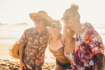 Group of couples friends have fun together at the beach in summer holiday vacation - people and travel activity lifestyle - young men and women enjoy friendship outdoor