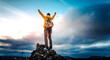 © Davide Angelini - Man with arms up celebrating on top of the mountains - Hiker enjoying freedom on a hill at sunset - Freedom, sport, success and mental health concept