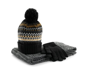 Woolen gloves, scarf and hat on white background