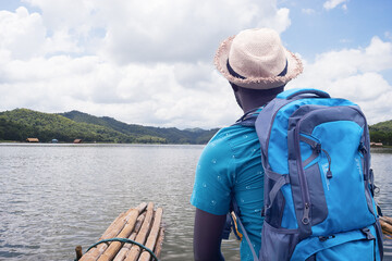 Wall Mural - African traveler man rafting in river with backpack