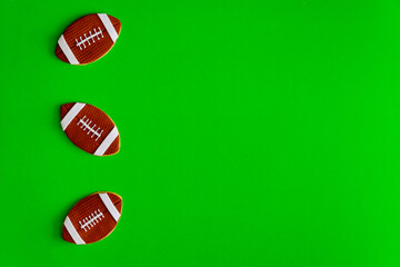 Cookie as an american football ball isolated on green background.