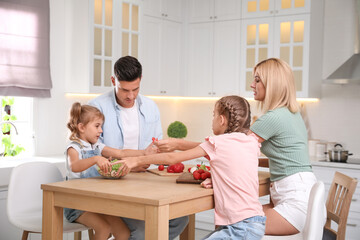 Poster - Happy family cooking together at table in modern kitchen