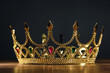 Leinwandbild Motiv Beautiful golden crown with gems on wooden table. Fantasy item