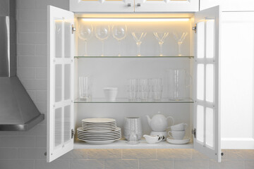 Canvas Print - Cabinet with crockery and glassware. Order in kitchen