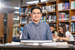 Portrait Asian teacher sitting in the library and classroom, University education, back to school after reopen Covid-19 outbreak concept
