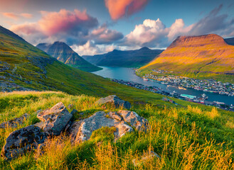 Wall Mural - Colorful sunrise in Klaksvik town. Aerial summer view from populat tourist attraction - Klakkur peak, Faroe Islands, Denmark, Europe. Amazing morning seascape of Atlantic Ocean.