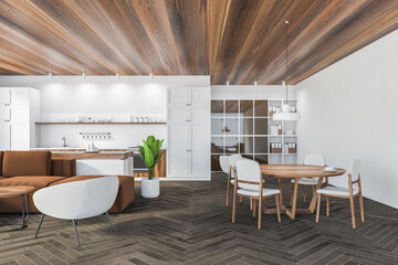 Living room with sofa, chairs and eating table with white kitchen set and shelf