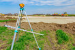 © Roman_23203 - Geodesist device with leveling rod on tripod on a building site