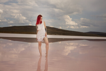 Wall Mural - red haired pretty girl on pink salt lake, crimea