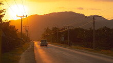 Classic Cuban Car On The Road At Sunset In Chivirico, Cuba