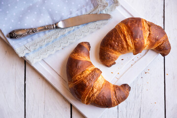 Sweet fresh croissants for breakfast on white background